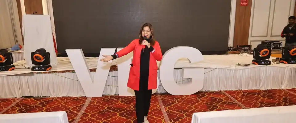 Anu Manocha in a red blazer hosting a VBG business network meet