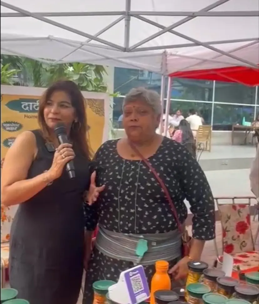 Anu Manocha interviewing a stall owner at an exhibition
