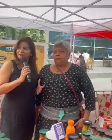 Anu Manocha interviewing a stall owner at an exhibition