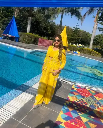 Anu Manocha in yellow at a poolside haldi venue