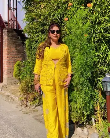 Anu Manocha in a yellow outfit at an outdoor haldi function