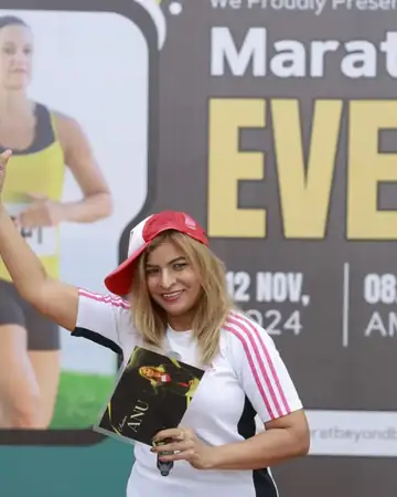 Anu Manocha cheering runners at a marathon event