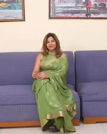 Anu Manocha seated, portrait in a green saree