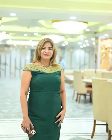 Anu Manocha in a green gown at a banquet hall