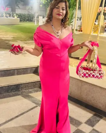 Anu Manocha in a pink gown at an outdoor event