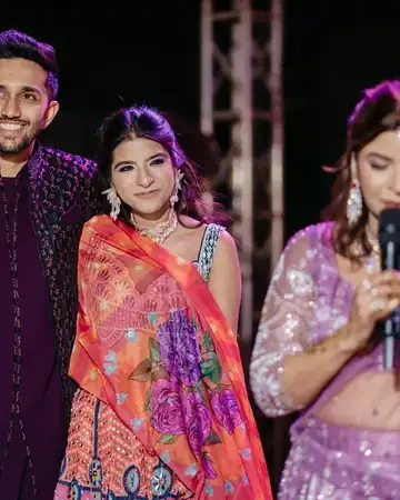Couple smiling as Anu Manocha hosts their sangeet