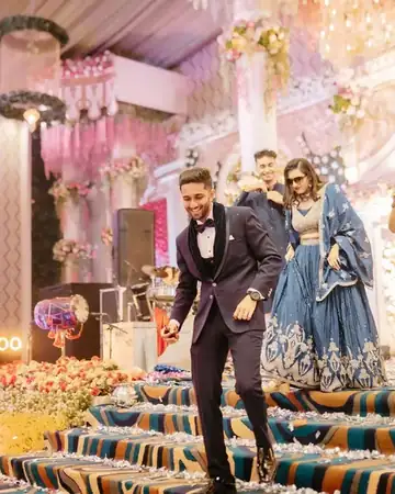 Couple entry on stage at a wedding sangeet, hosted by Anu Manocha