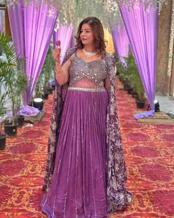 Anu Manocha in a lehenga at a wedding venue entrance