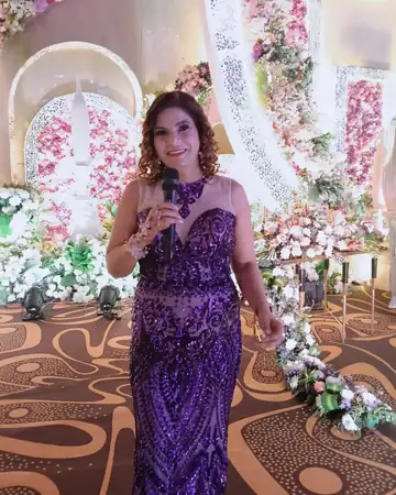 Anu Manocha in a purple gown hosting a wedding reception