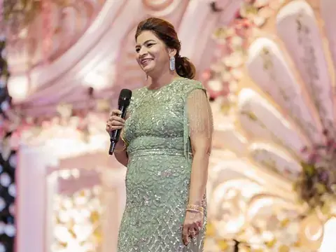 Anu Manocha in a green sequinned gown anchoring a wedding function